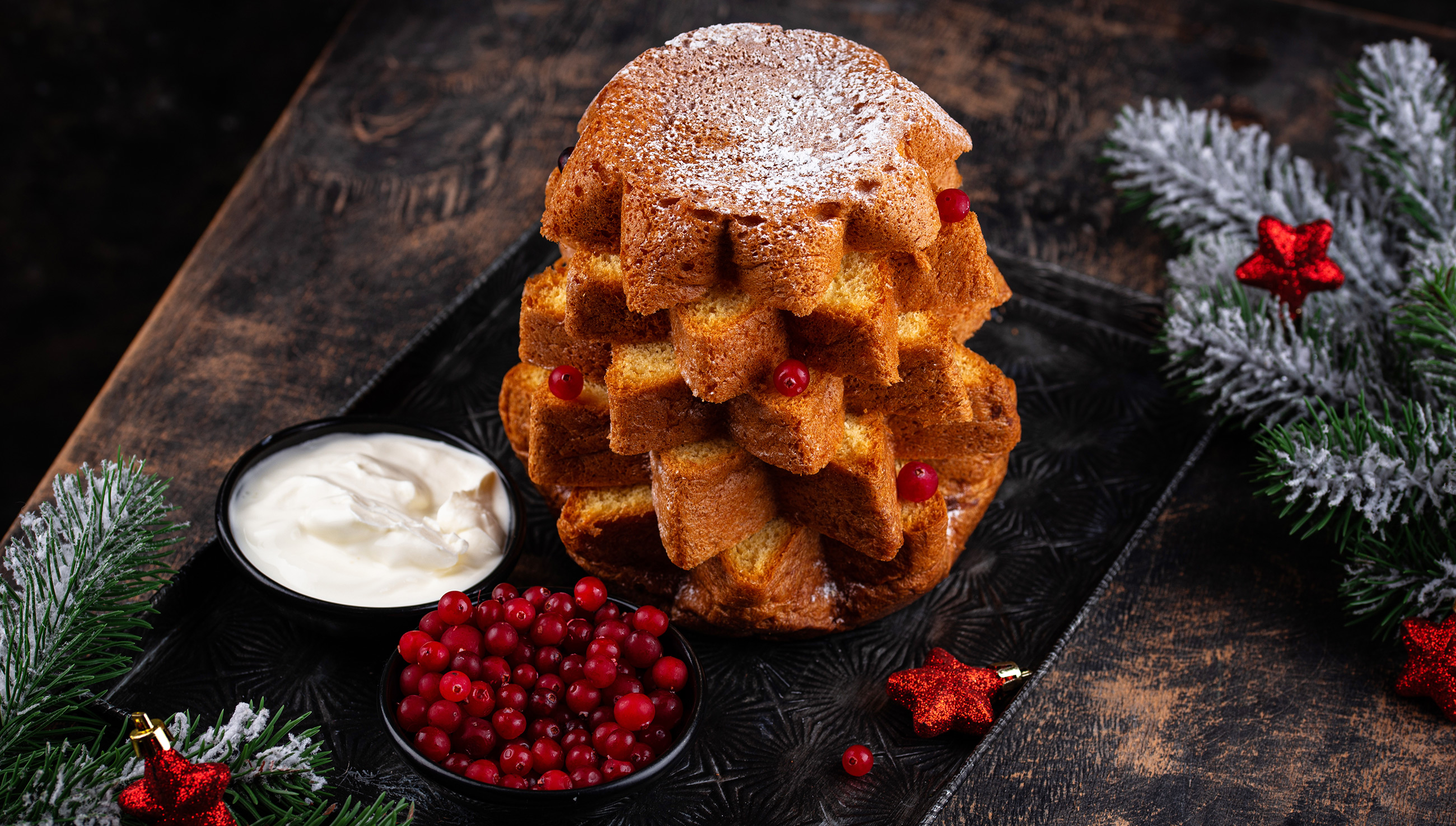 Dolci con pandoro serviti in bicchiere con crema, frutti rossi e decorazioni natalizie